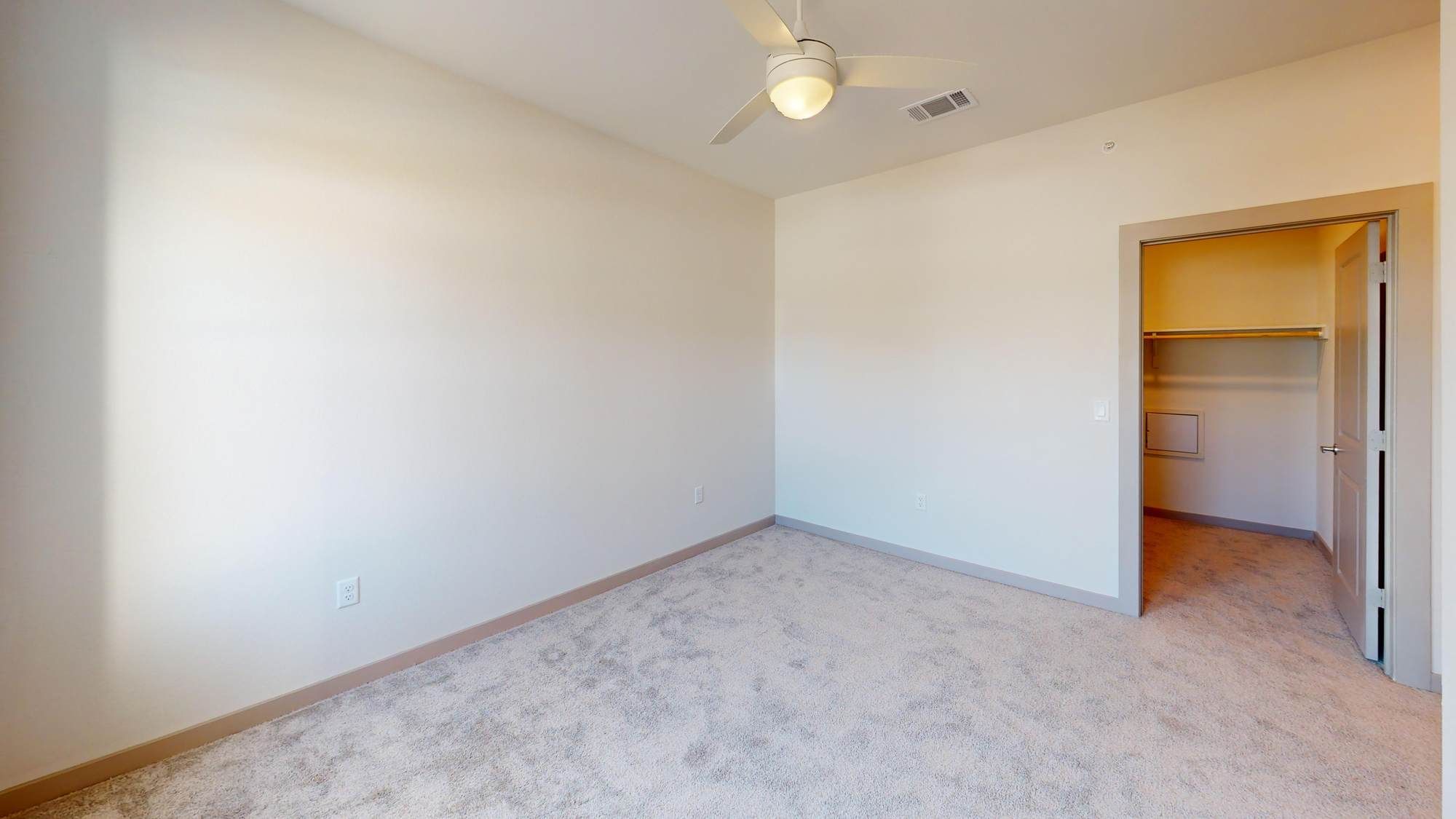 Bedroom at Ryder Ridge with plush carpeting, neutral walls, and a ceiling fan for year-round comfort.