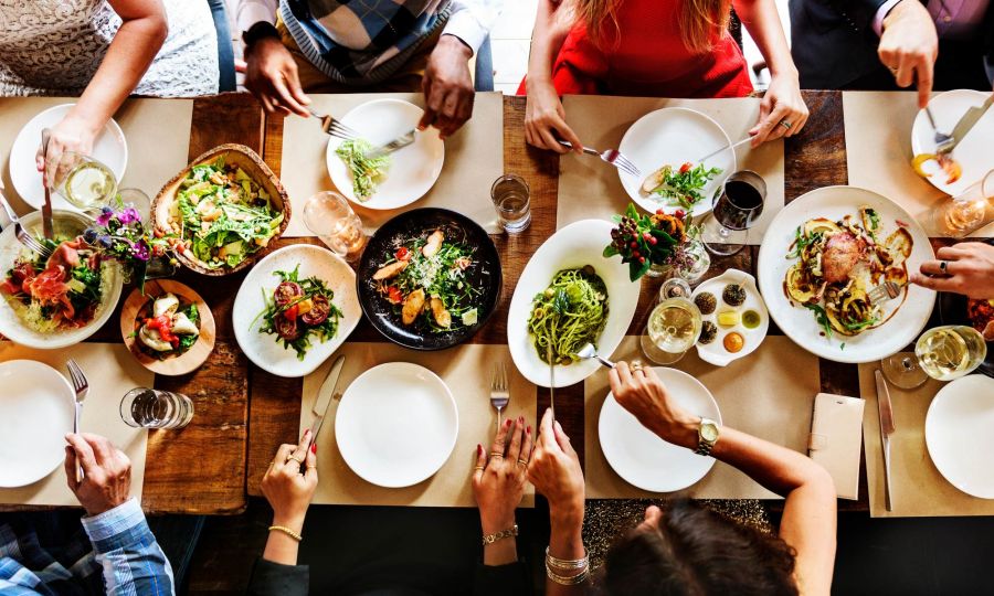 Friends sharing a meal at a local Austin restaurant near Ryder Ridge, featuring fresh food and a warm, social atmosphere.