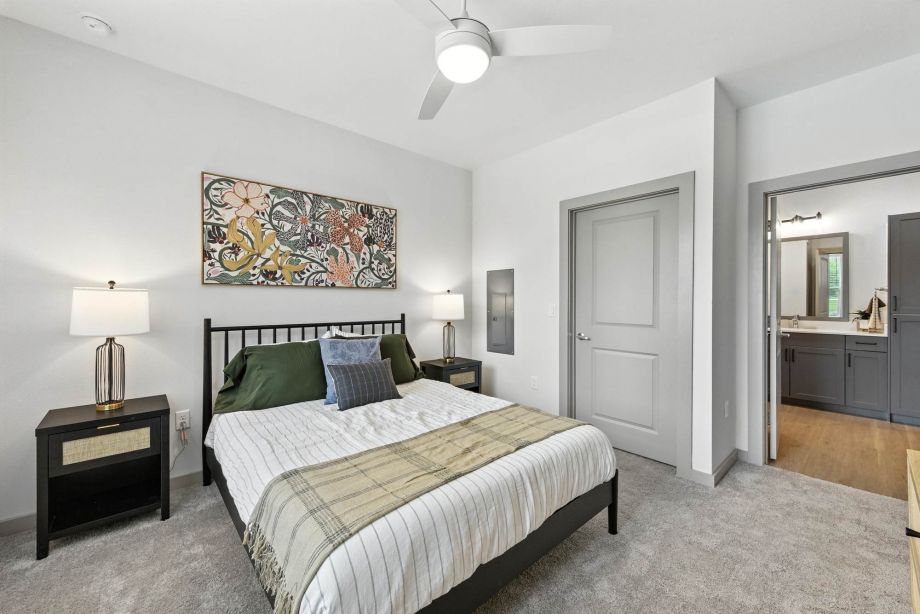 Bedroom at Ryder Ridge featuring neutral tones, plush carpeting, and modern ceiling fan lighting.